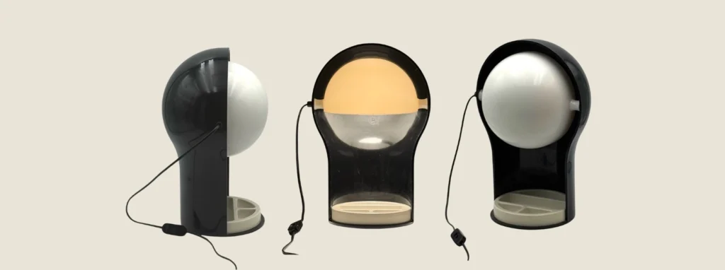 Three-angle view of the iconic black Artemide Telegono desk lamp designed by Vico Magistretti, showing the rotating shell and base tray