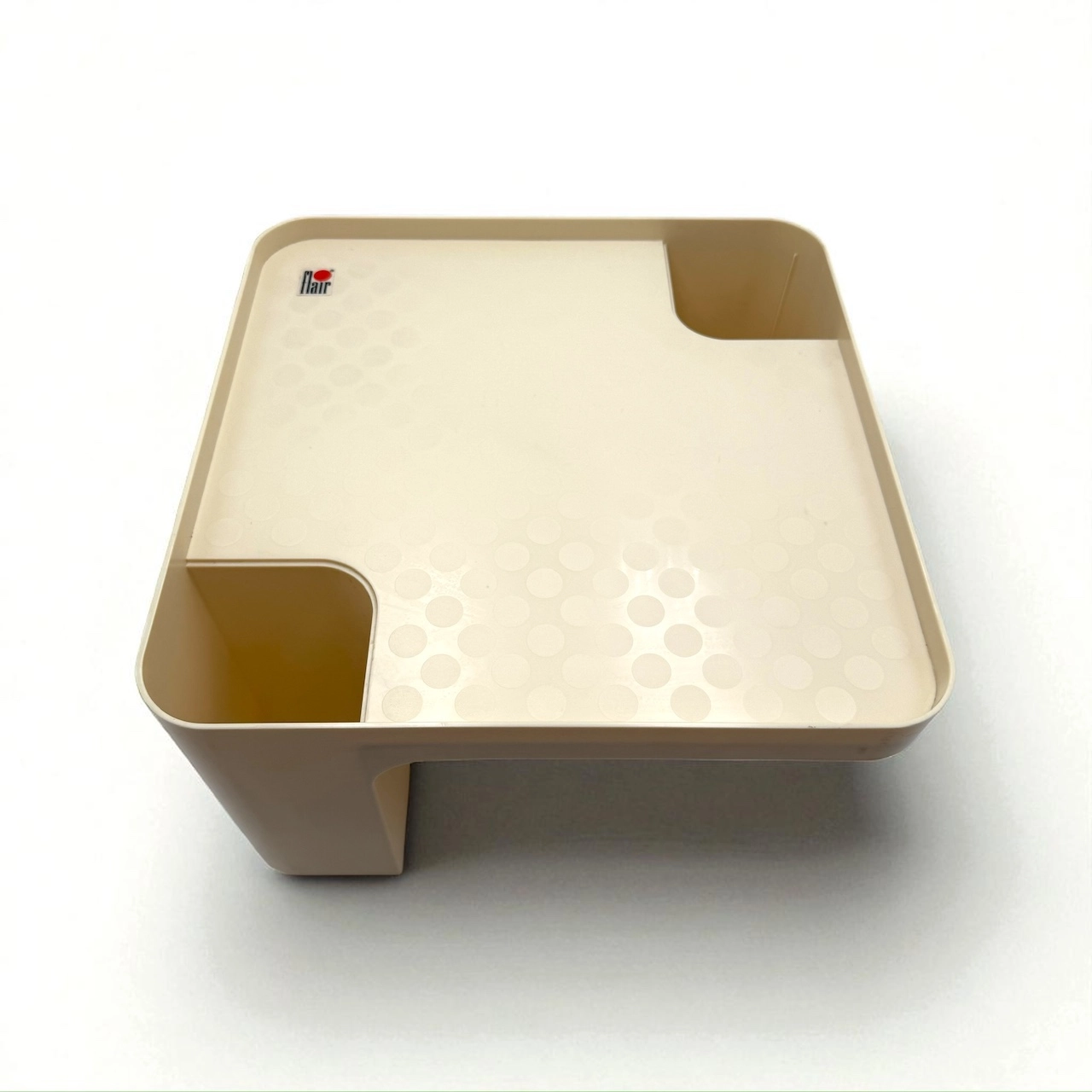 Detail of molded plastic surface and Flair Holland branding on a side table