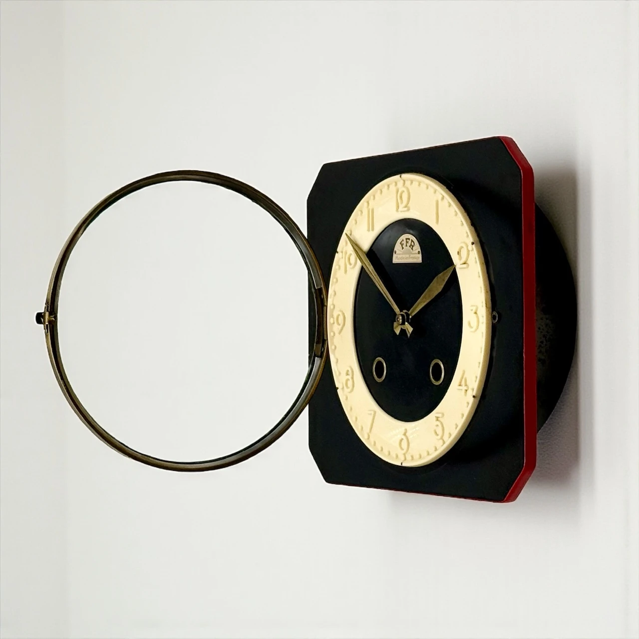 Authentic vintage French wall clock by FFR 1950s, black and ivory Formica with coral edge, brass hands, glass window and original key, Made in France
