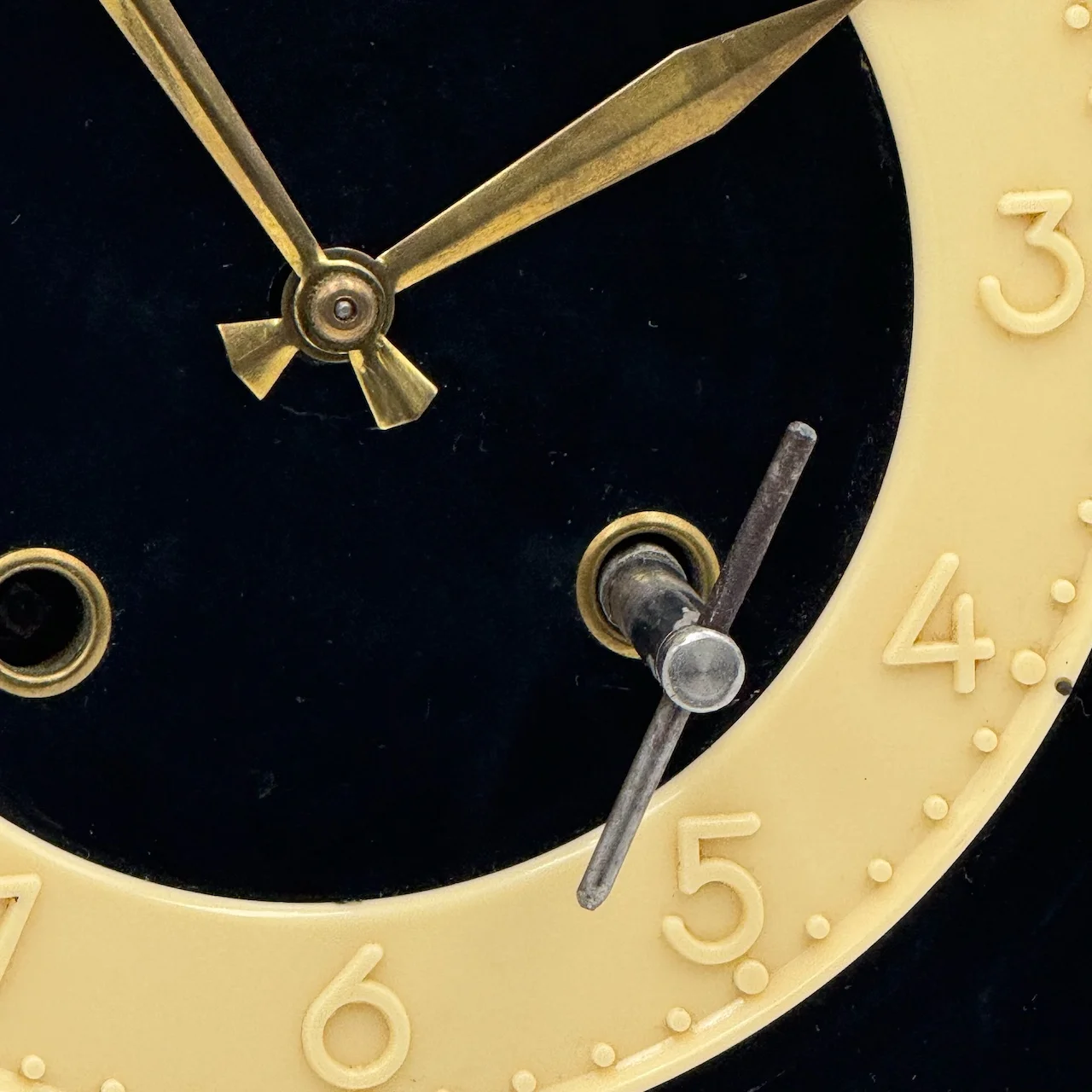 Authentic vintage French wall clock by FFR 1950s, black and ivory Formica with coral edge, brass hands, glass window and original key, Made in France