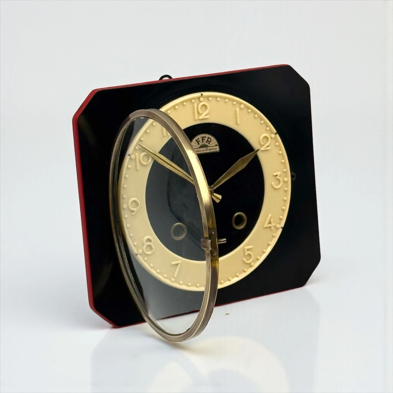 Authentic vintage French wall clock by FFR 1950s, black and ivory Formica with coral edge, brass hands, glass window and original key, Made in France