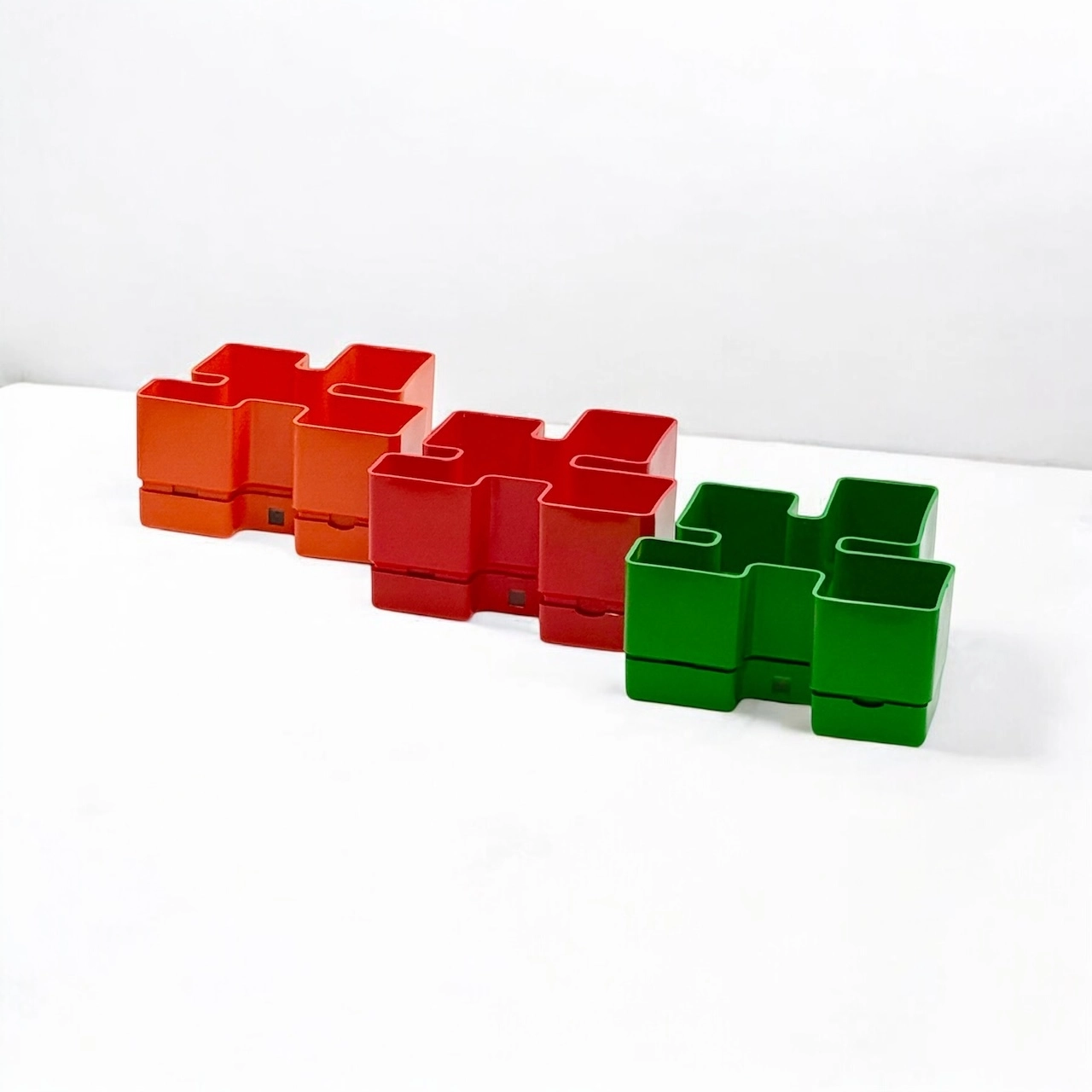 Colorful-modular-plastic-planters-trio-from-the-1970s-in-orange-red-and-green-featuring-bold-geometric-design-and-stacked-configuration