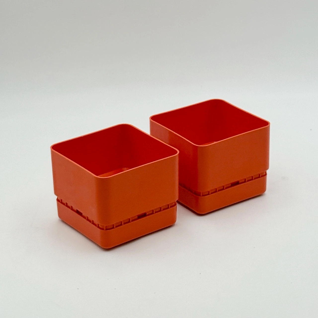 Vastill orange planters by Nena Balsari with water reservoir