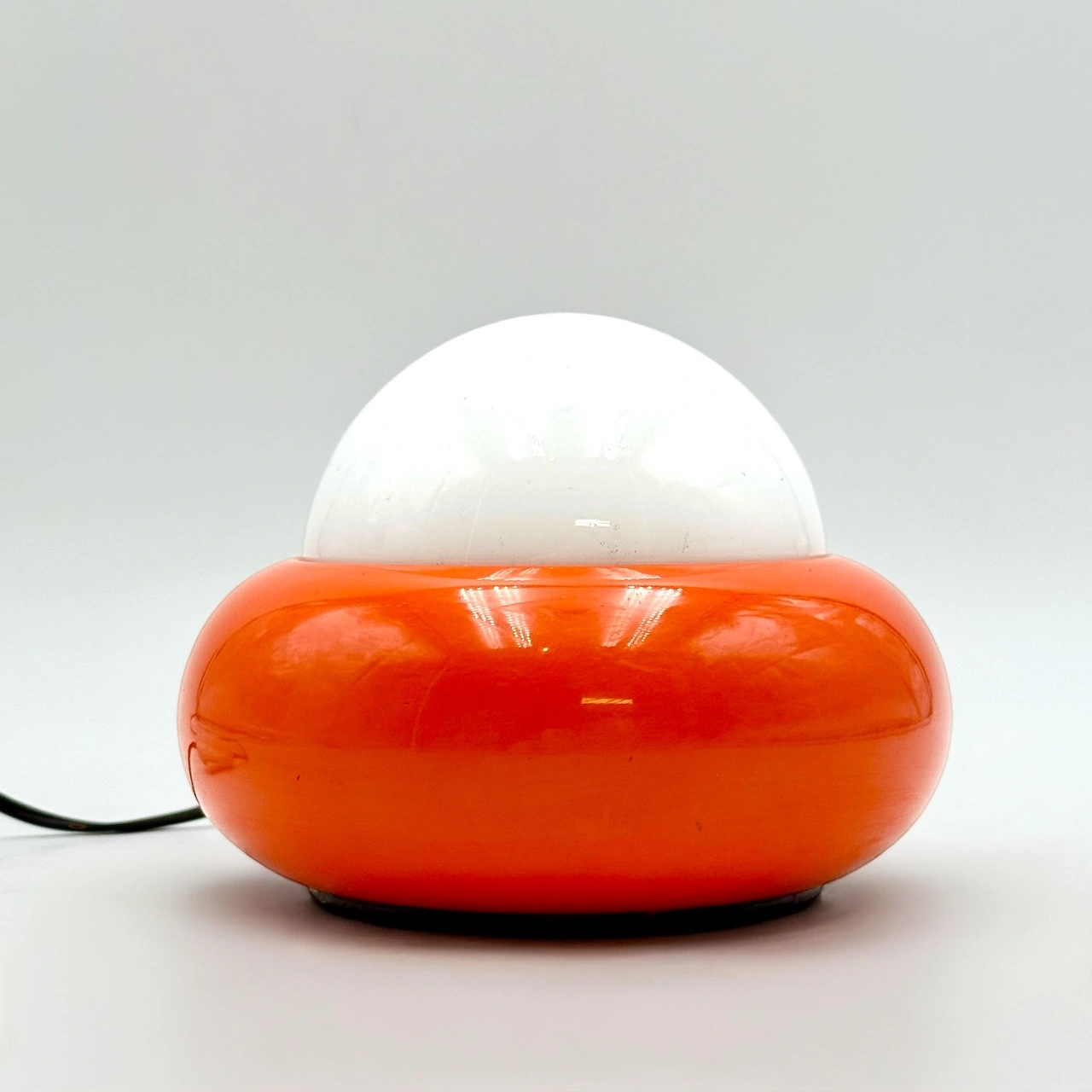 Vintage space age lamp with orange UFO base and white glass dome by Luci Milano