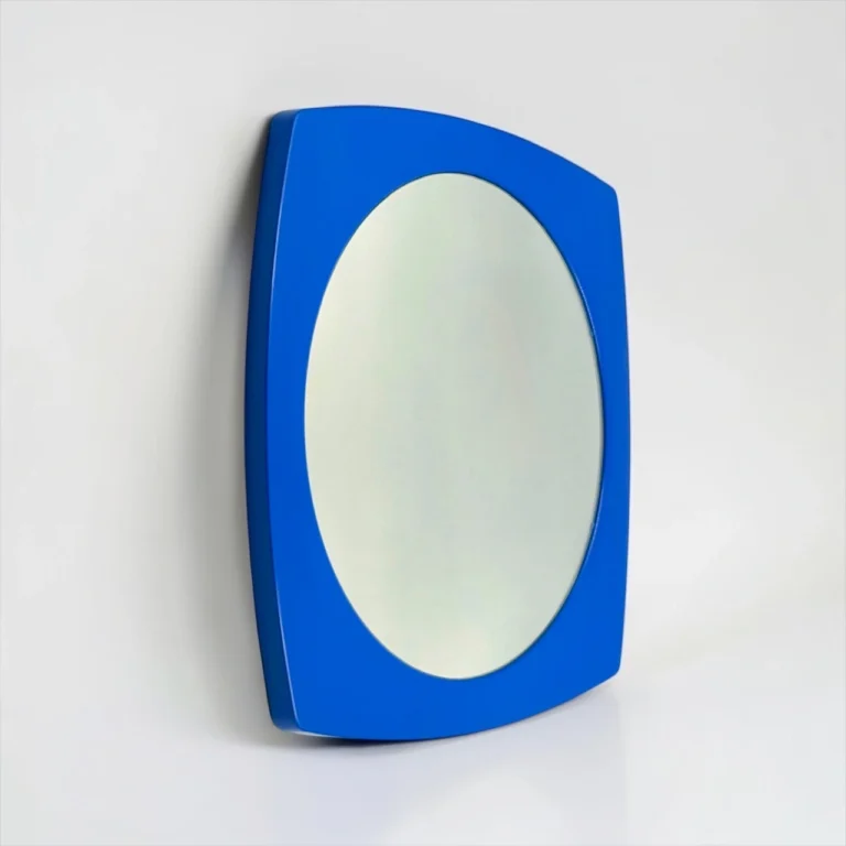 Blue curved wall mirror with an oval reflective surface set in a blue frame on a white background.
